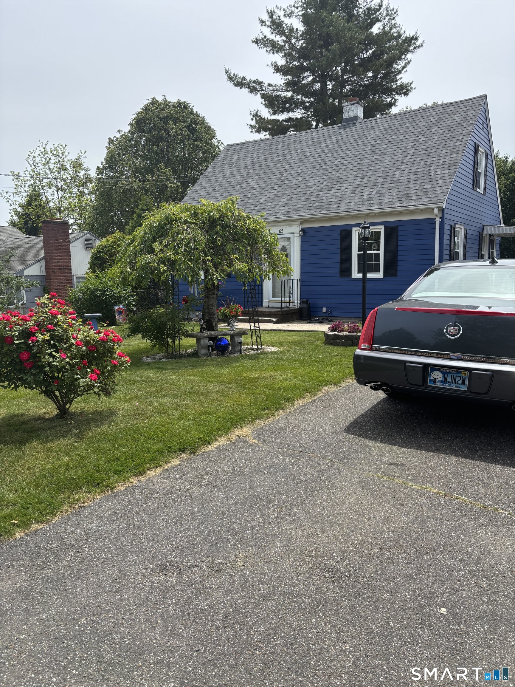 65 Cass Street Meriden, CT 06450 - Photo 4 of 21 a car parked in front of a brick house
