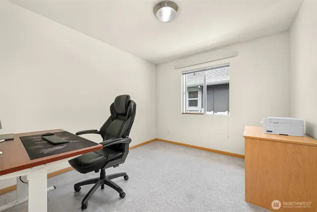 a view of a workspace with furniture