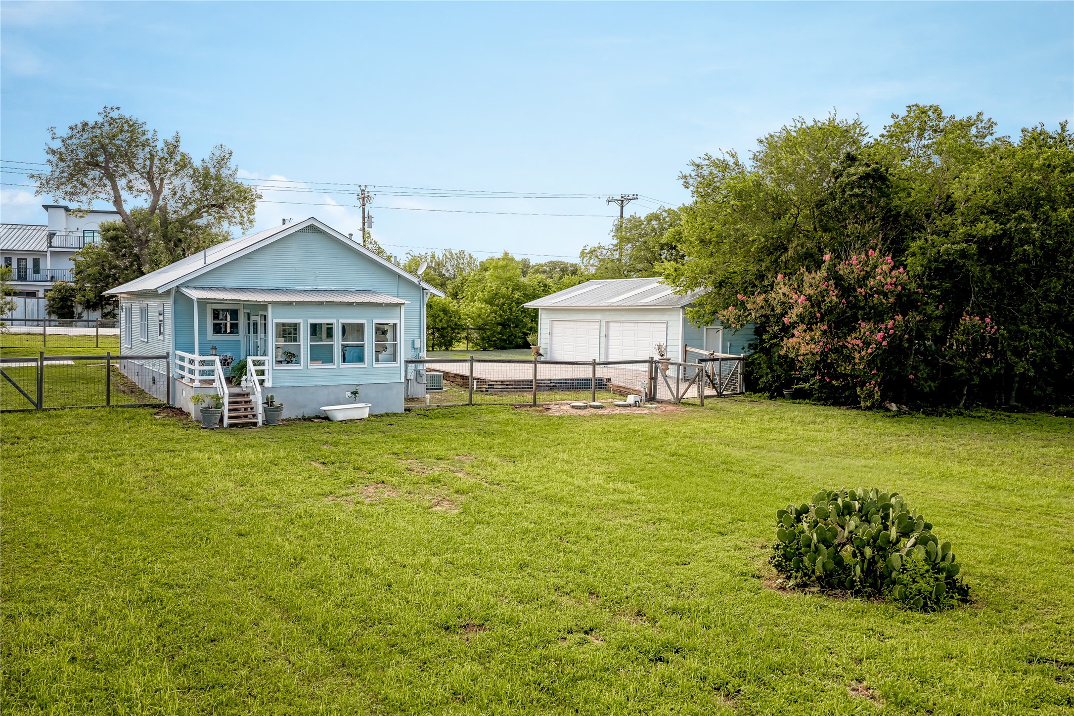 372 Old Lockhart Road Lockhart, TX 78644 - Photo 36 of 40 A charming single-story residence with a covered porch and detached garage, framed by a spacious yard.