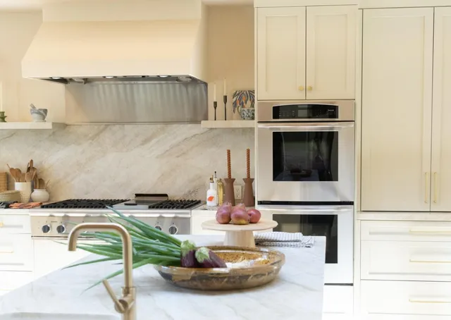 a kitchen with a stove and a white cabinets