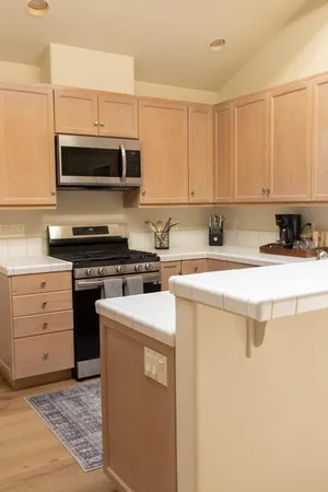 a view of a dining room with furniture wooden floor and a chandelier