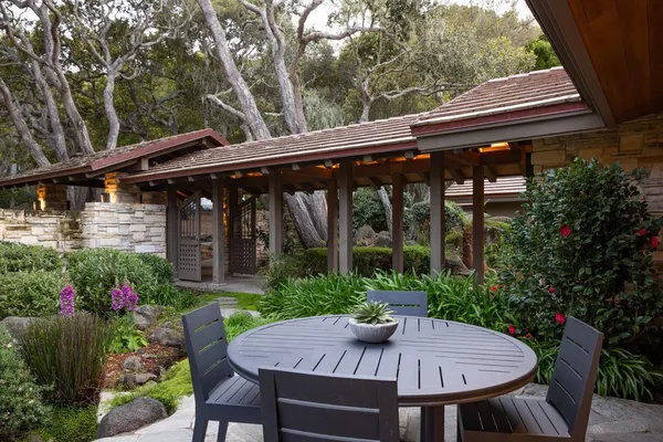 a view of house with backyard and furniture