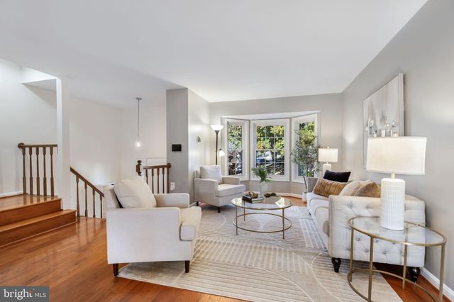 a living room with couches and a table with wooden floor