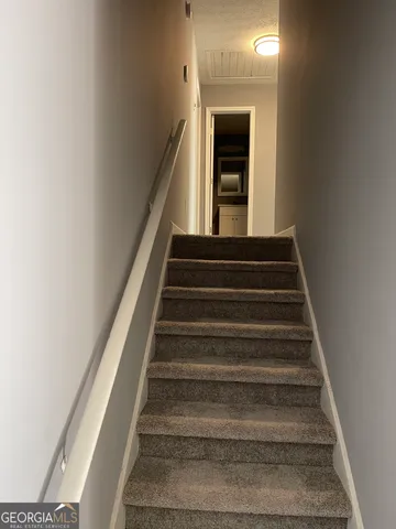 en empty room with windows and ceiling fan