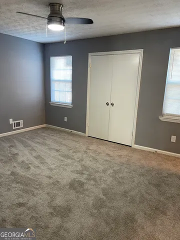 a white toilet sitting next to a bath tub