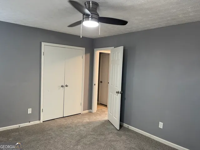 a view of a hallway with a refrigerator