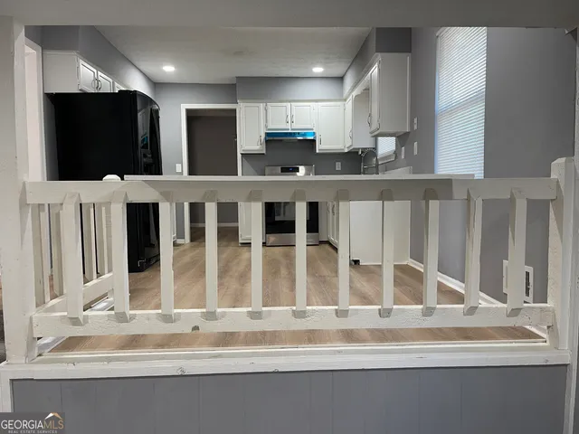 a kitchen with stainless steel appliances kitchen island granite countertop a sink and cabinets