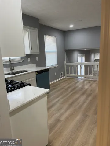 a kitchen with a sink stove and cabinets