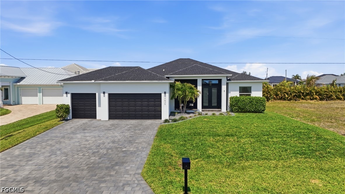 4635 Northwest 32nd Street Cape Coral, FL 33993 - Photo 1 of 30 a front view of a house with a garden and yard