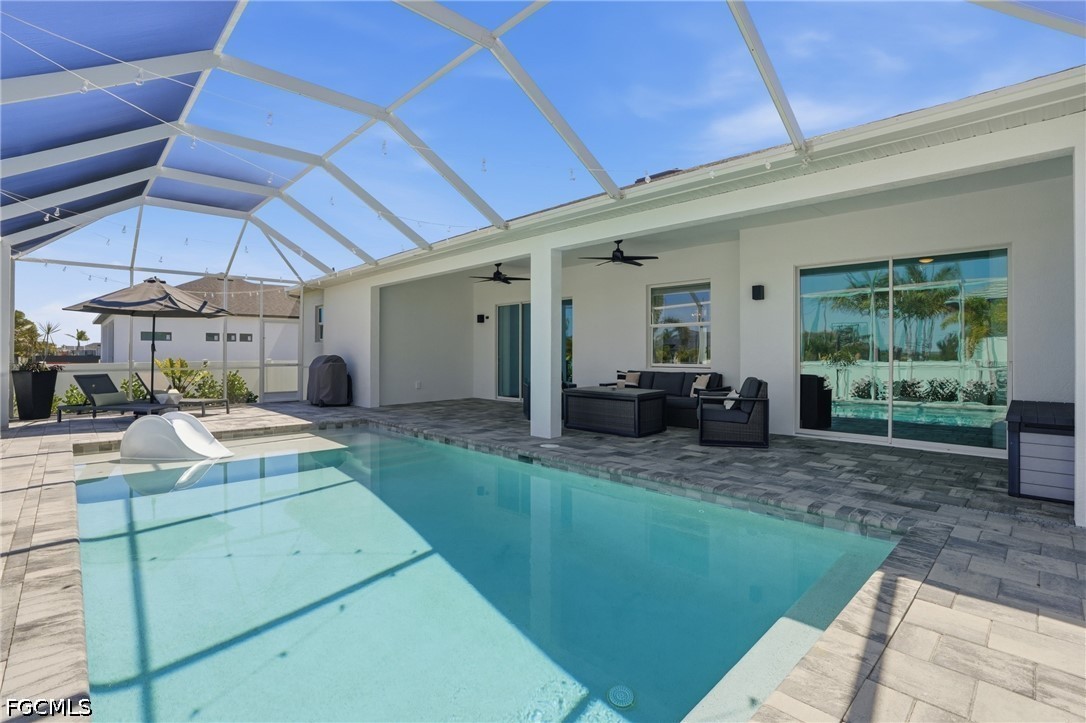 4635 Northwest 32nd Street Cape Coral, FL 33993 - Photo 26 of 30 a view of a backyard with table and chairs under an umbrella