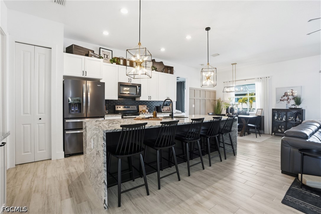 4635 Northwest 32nd Street Cape Coral, FL 33993 - Photo 7 of 30 a large kitchen with a table and chairs