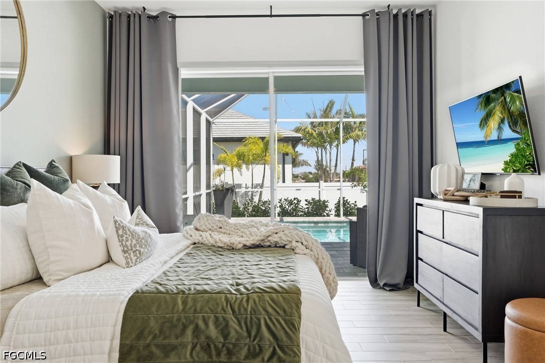 4635 Northwest 32nd Street Cape Coral, FL 33993 - Photo 10 of 30 a bedroom with a bed and a large window