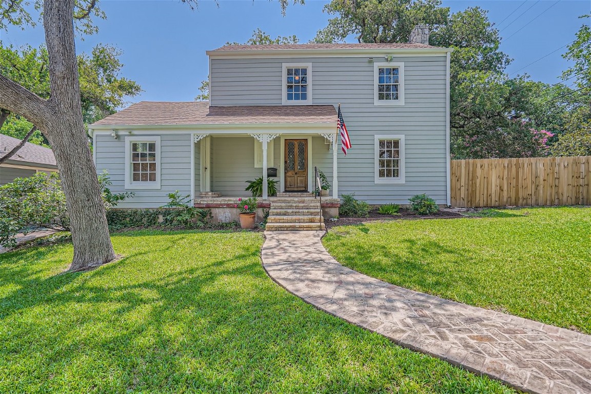 a front view of house with yard and green space