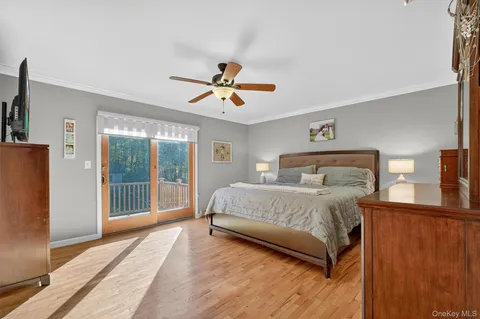 a bedroom with a large bed and a chandelier