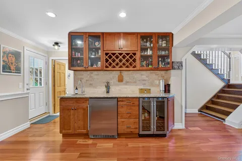 a view of kitchen with wooden floor and cabinets
