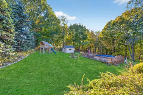 a view of a house with a backyard and a patio