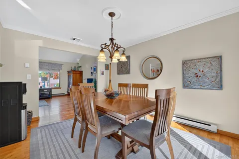 a view of a dining room with furniture and a chandelier