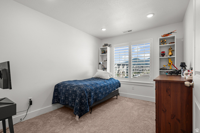 2706 West Maple Street, Unit 285 Mapleton, UT 84664 - Photo 23 of 36 Carpeted room featuring a window with white plantation shutters, two built-in shelving units, and recessed lighting
