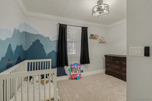 a bedroom with furniture and baby bed