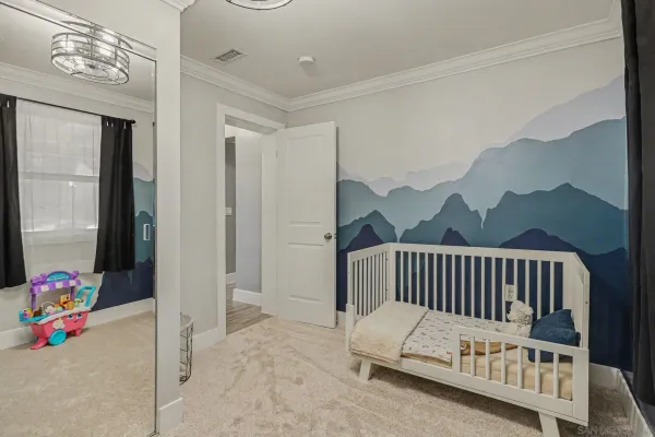 a white bedroom with a bed and a window