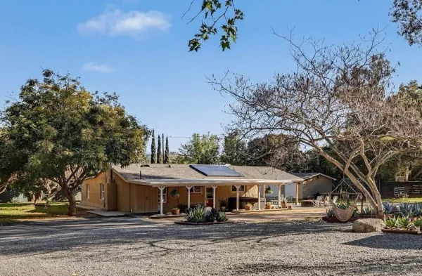 a front view of a house with garden