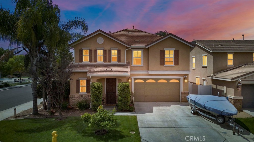 a front view of a house with a garden and plants
