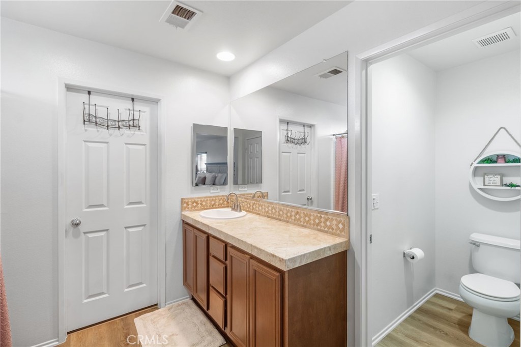 641 Amaranta Avenue Perris, CA 92571 - Photo 14 of 31 a bathroom with a sink a toilet and a mirror