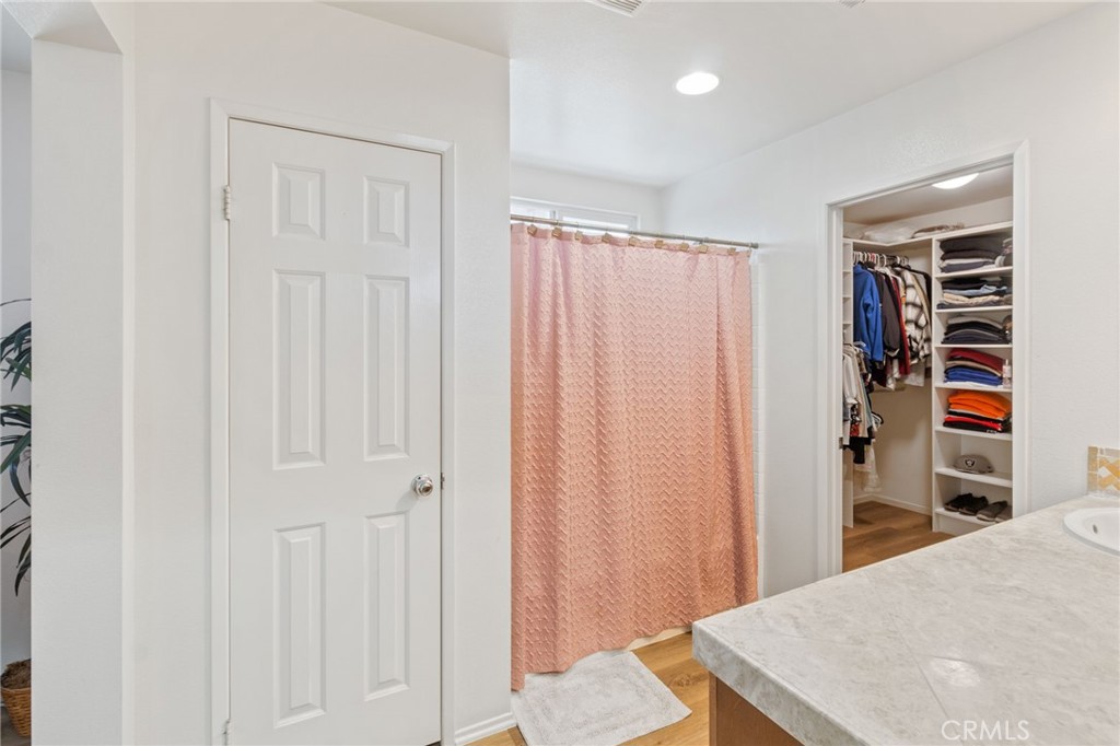 641 Amaranta Avenue Perris, CA 92571 - Photo 15 of 31 a view of a bedroom with wooden floor and closet