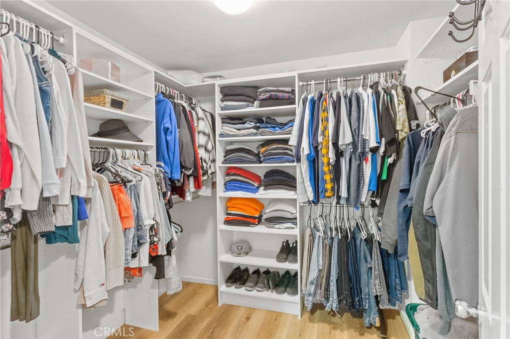 641 Amaranta Avenue Perris, CA 92571 - Photo 16 of 31 a view of walk in closet with clothes and shoes