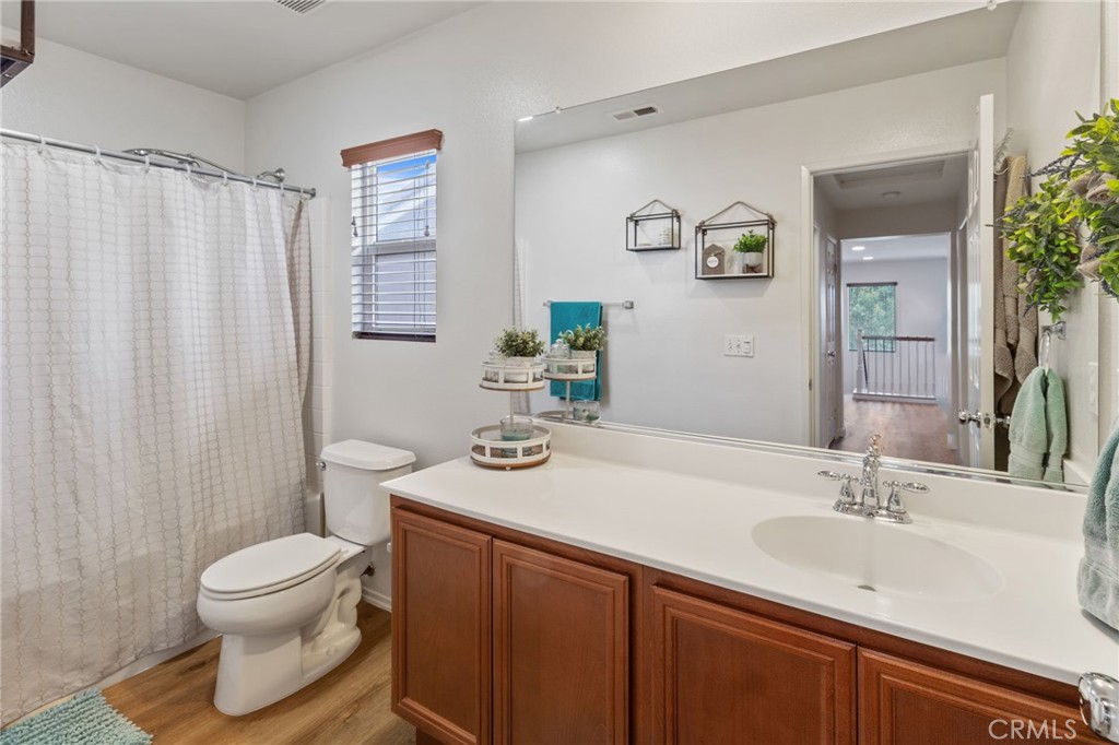641 Amaranta Avenue Perris, CA 92571 - Photo 19 of 31 a bathroom with a sink toilet and shower