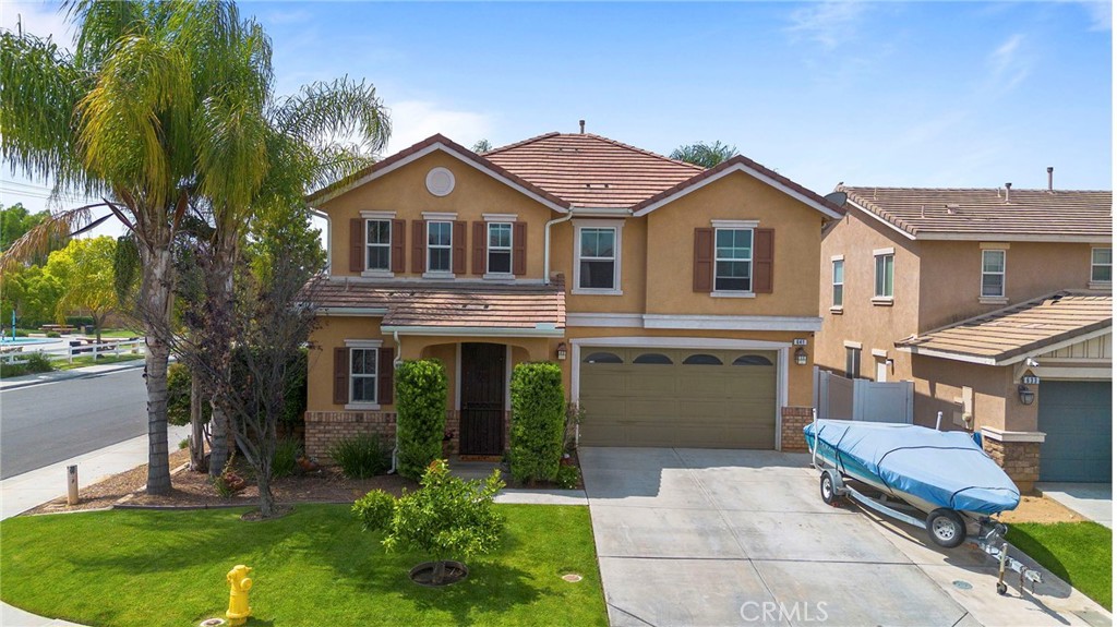 641 Amaranta Avenue Perris, CA 92571 - Photo 2 of 31 a front view of a house with a yard and garage