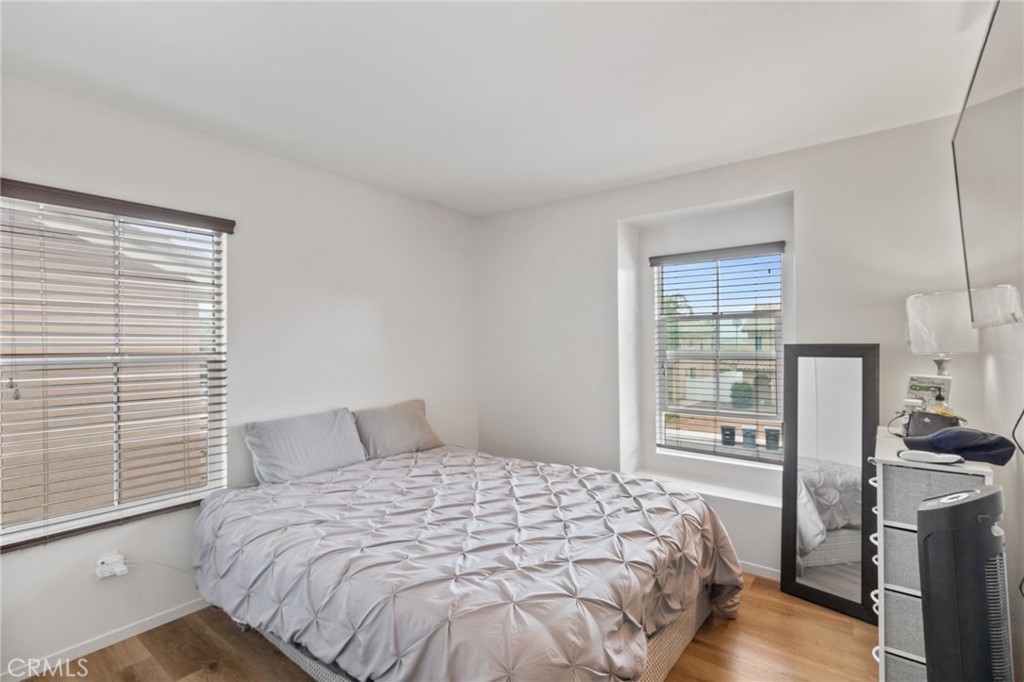 641 Amaranta Avenue Perris, CA 92571 - Photo 21 of 31 a bedroom with a bed and wooden floor