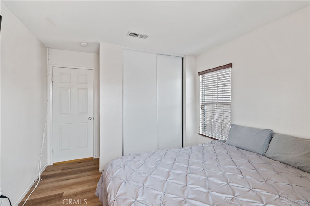 641 Amaranta Avenue Perris, CA 92571 - Photo 22 of 31 a bedroom with a large bed and a window