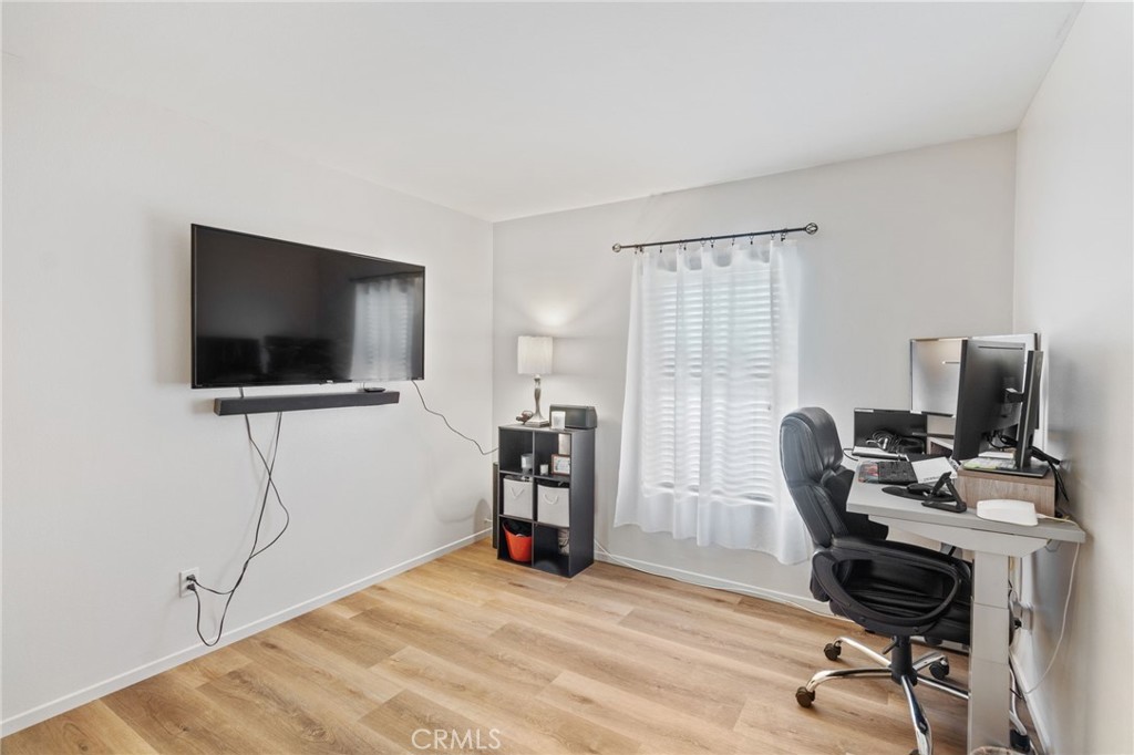 641 Amaranta Avenue Perris, CA 92571 - Photo 24 of 31 a view of a workspace with furniture and a flat screen tv