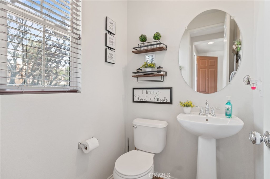 641 Amaranta Avenue Perris, CA 92571 - Photo 25 of 31 a bathroom with a toilet sink and mirror