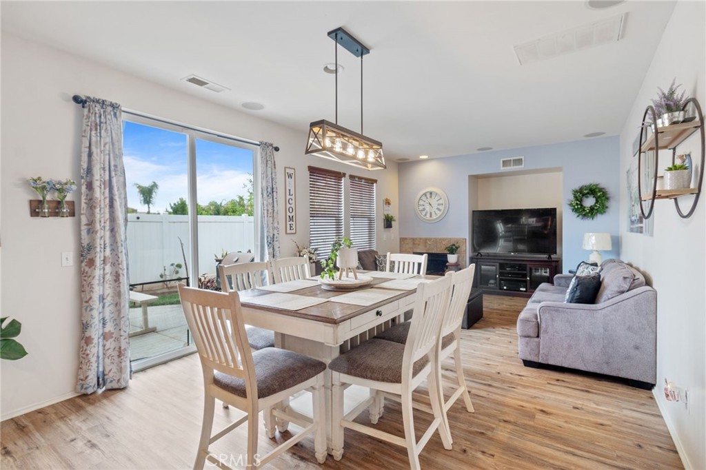 641 Amaranta Avenue Perris, CA 92571 - Photo 6 of 31 a view of a dining room with furniture window and wooden floor