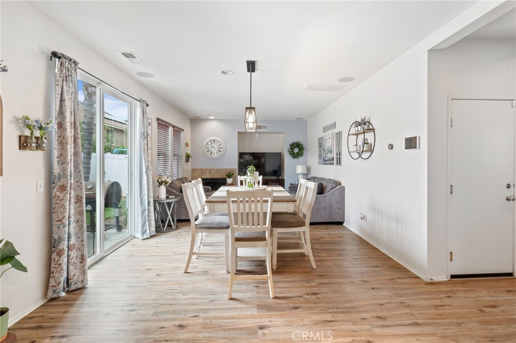 641 Amaranta Avenue Perris, CA 92571 - Photo 7 of 31 a dining room with furniture a chandelier and wooden floor