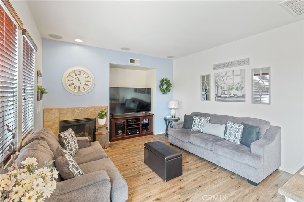 641 Amaranta Avenue Perris, CA 92571 - Photo 8 of 31 a living room with furniture a fireplace and a flat screen tv