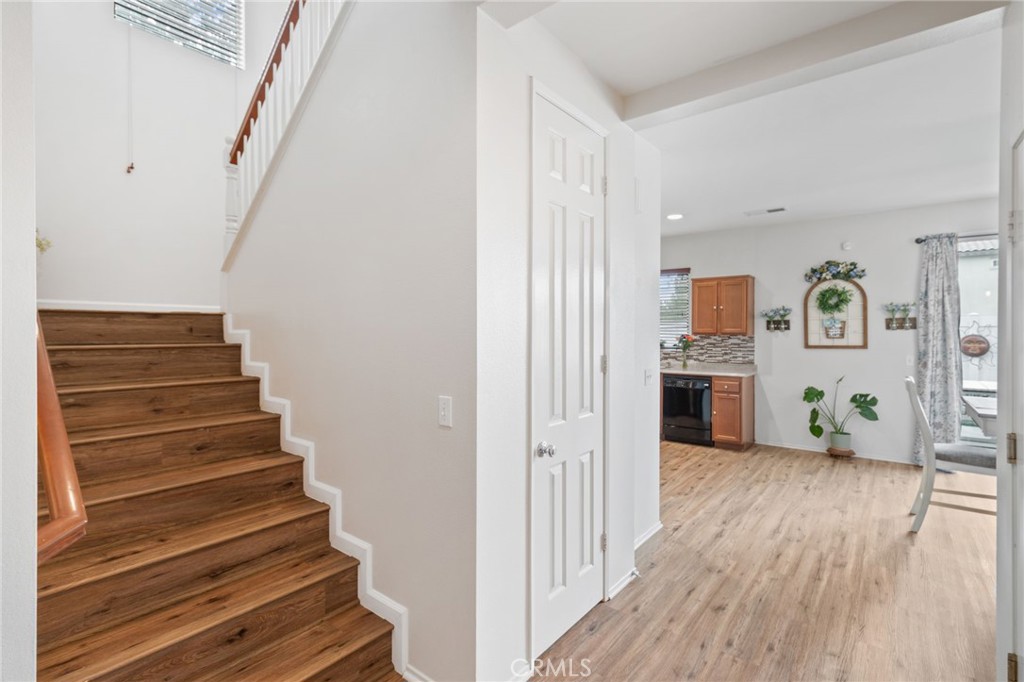 641 Amaranta Avenue Perris, CA 92571 - Photo 9 of 31 a view of a hallway with wooden floor and staircase
