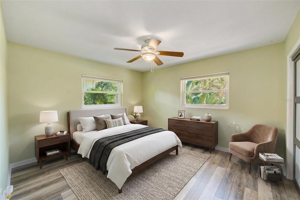 14079 Victoria Road Largo, FL 33774 - Photo 19 of 46 a bedroom with a bed and a chandelier
