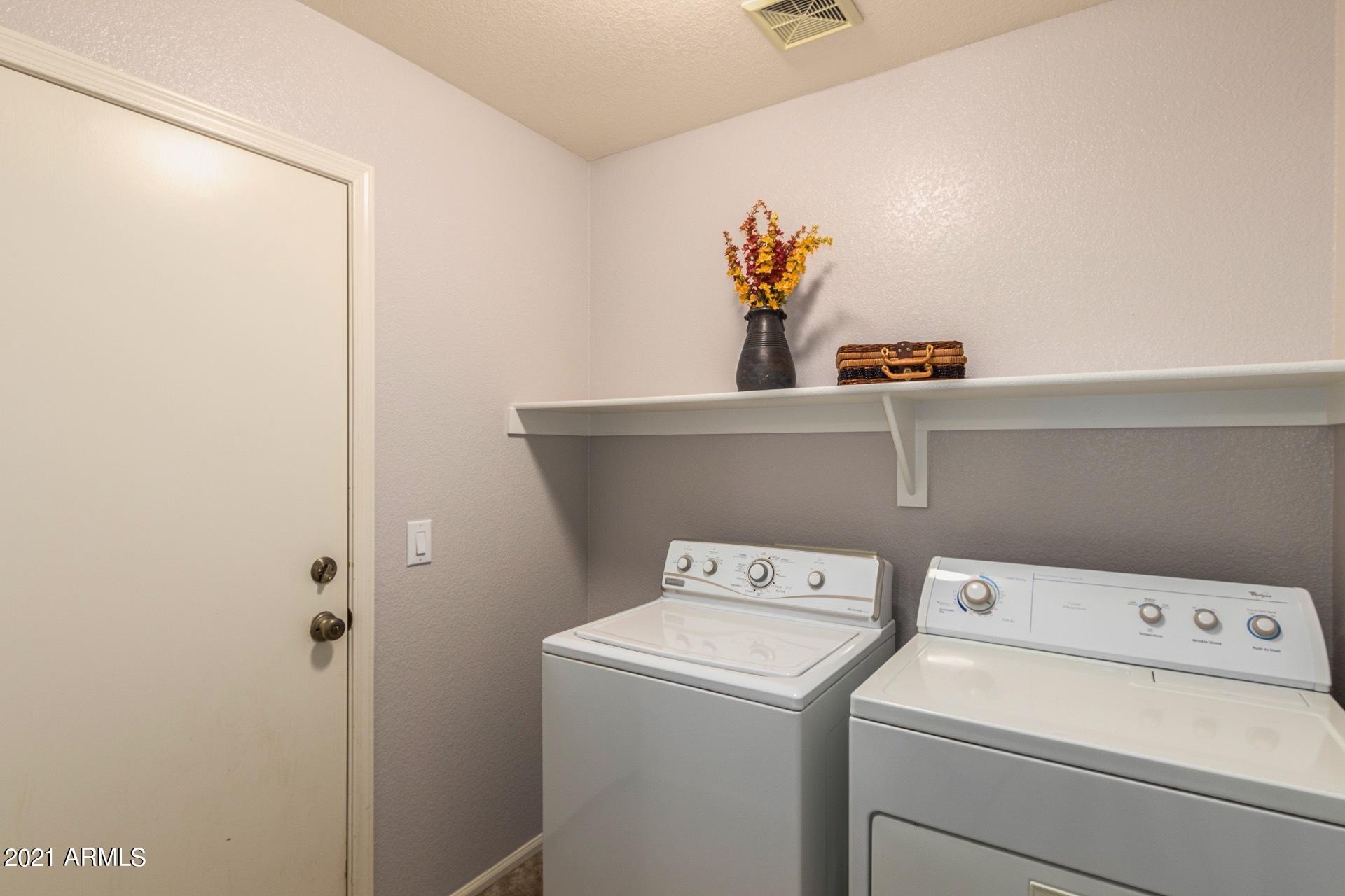 2438 West Running Deer Trail Phoenix, AZ 85085 - Photo 13 of 28 a utility room with dryer and washer