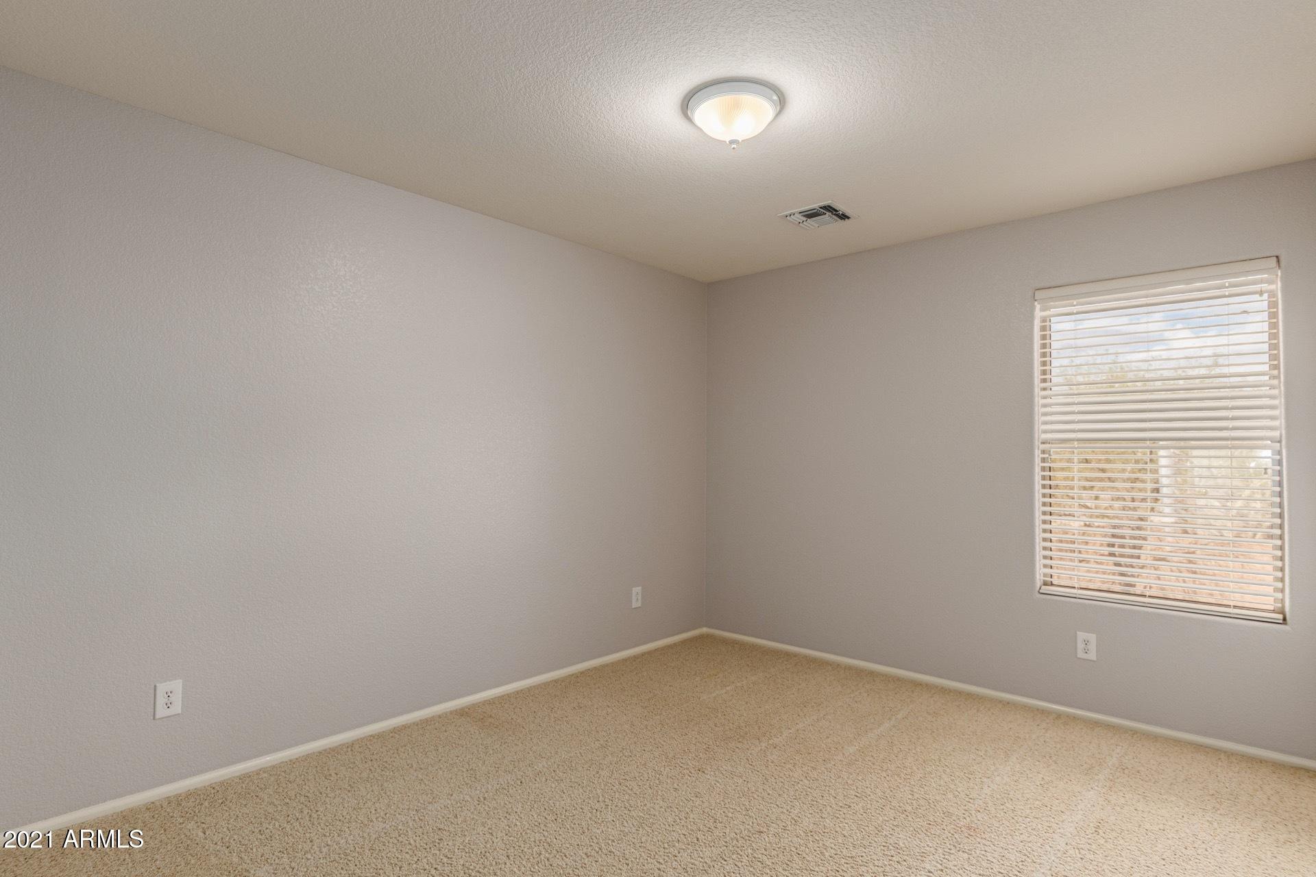 2438 West Running Deer Trail Phoenix, AZ 85085 - Photo 15 of 28 an empty room with a window