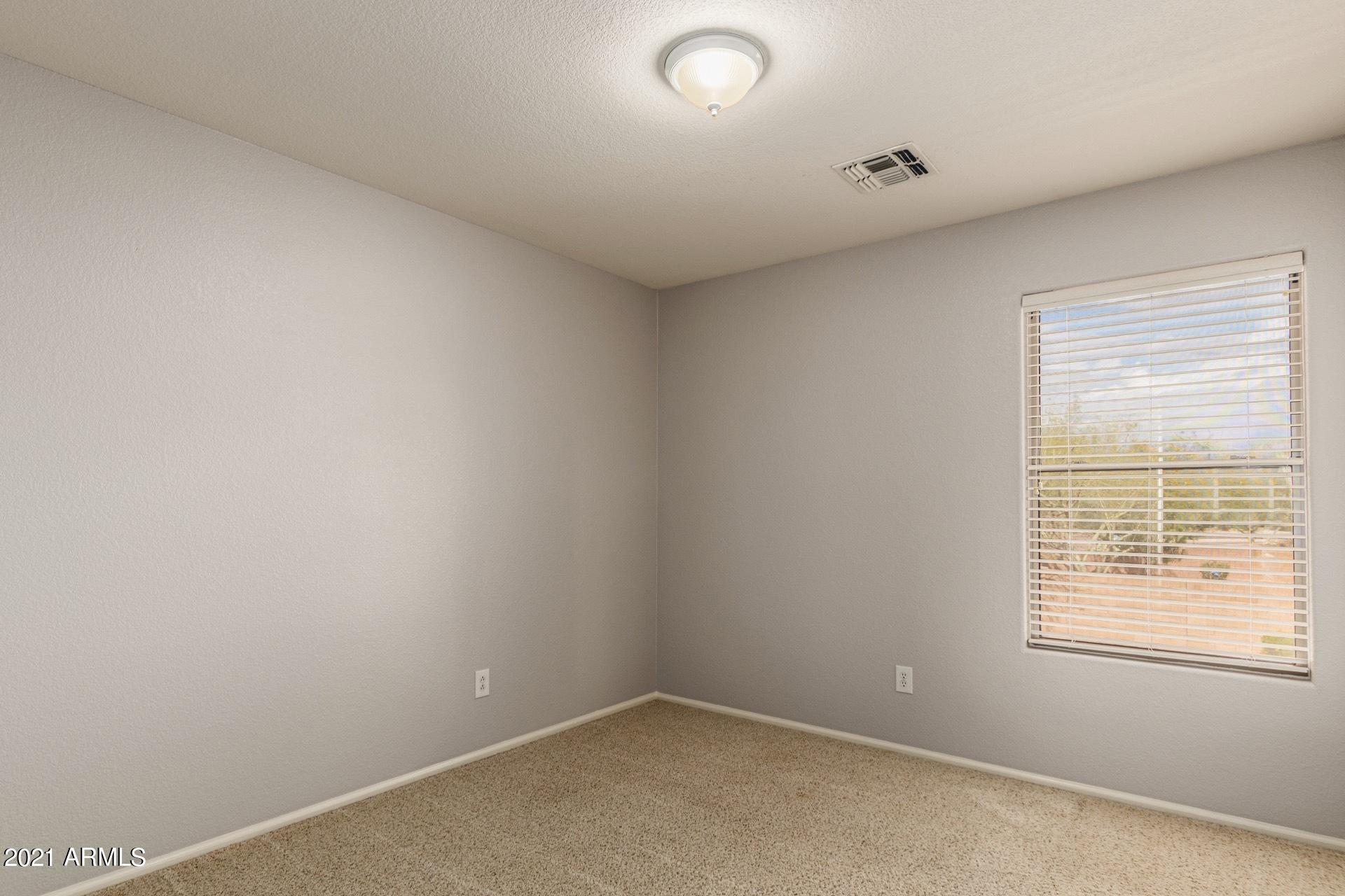 2438 West Running Deer Trail Phoenix, AZ 85085 - Photo 17 of 28 an empty room with a window