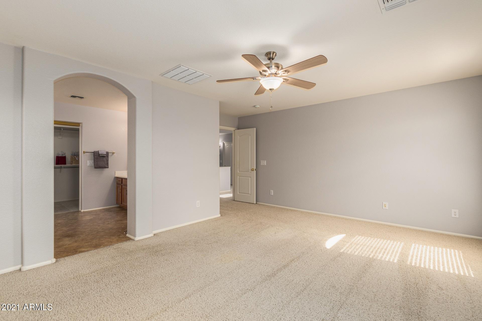 2438 West Running Deer Trail Phoenix, AZ 85085 - Photo 20 of 28 a view of empty room with a ceiling fan