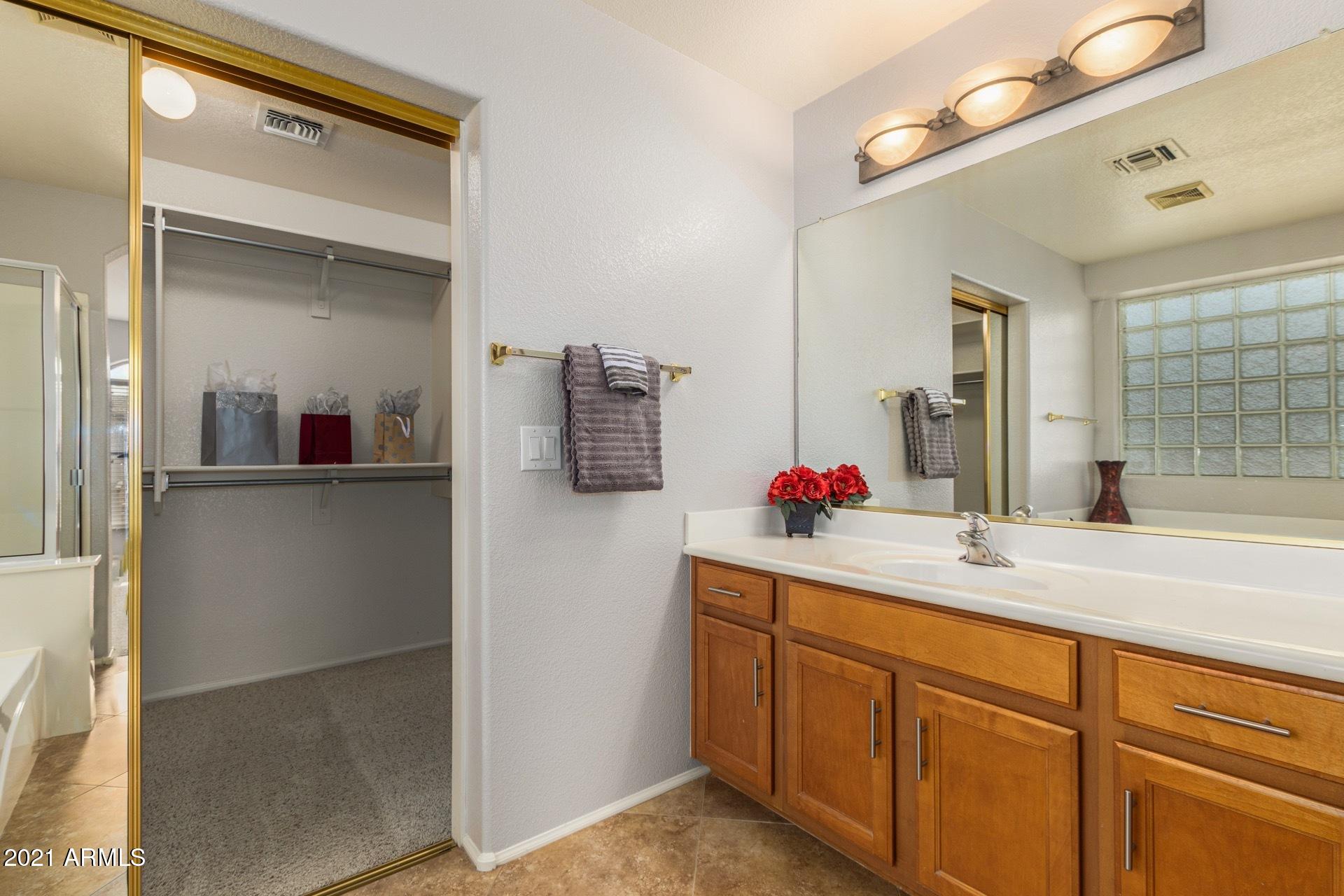 2438 West Running Deer Trail Phoenix, AZ 85085 - Photo 21 of 28 a bathroom with a sink and mirror