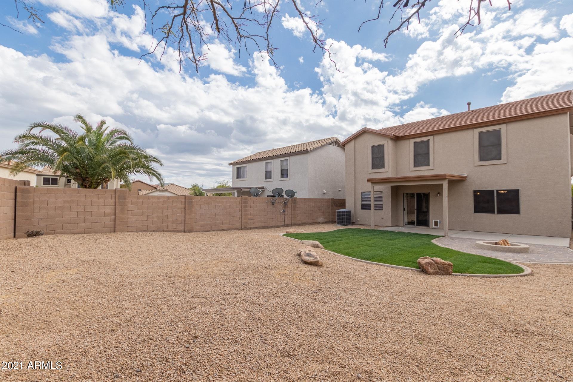 2438 West Running Deer Trail Phoenix, AZ 85085 - Photo 22 of 28 a front view of a house with a yard and garage