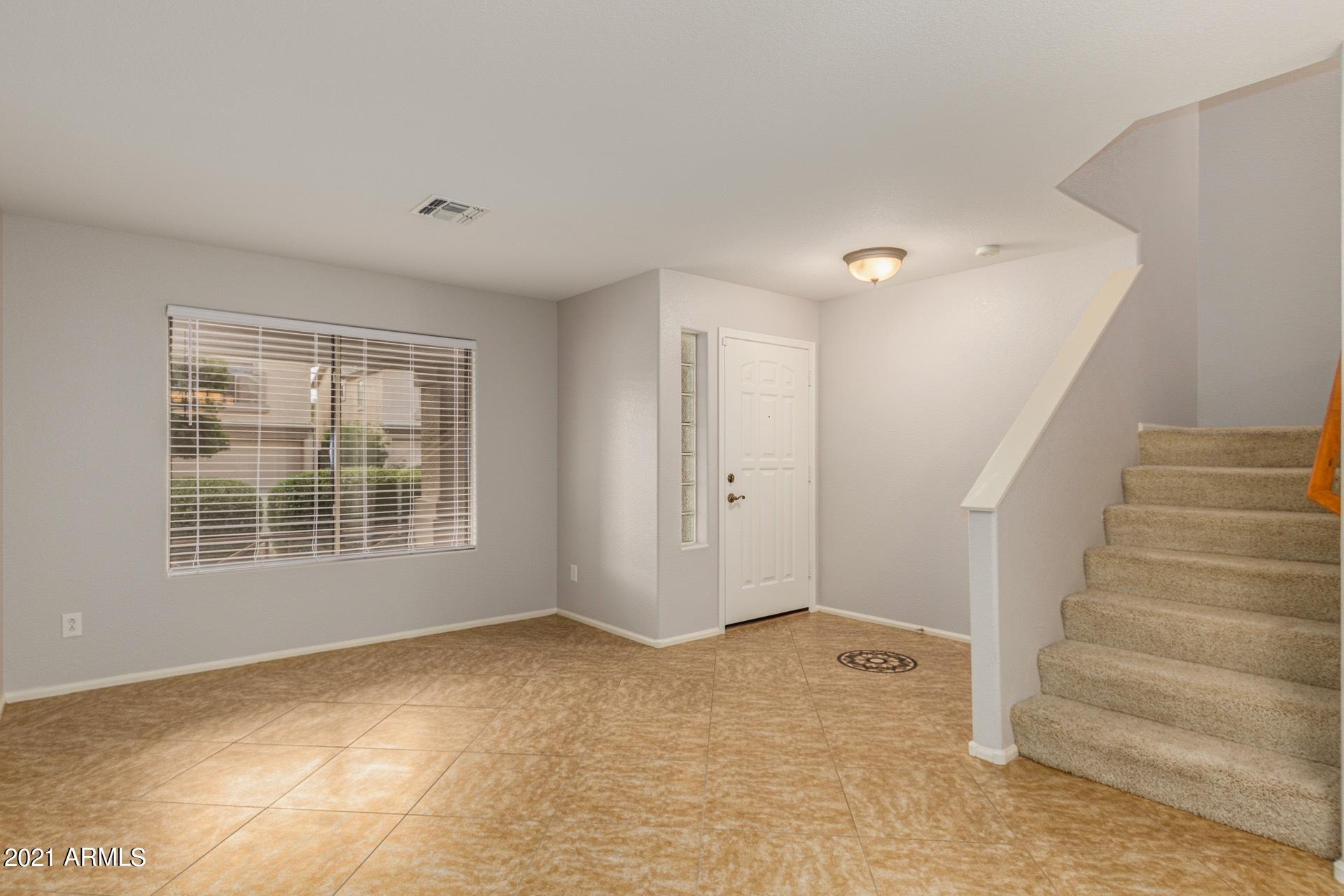 2438 West Running Deer Trail Phoenix, AZ 85085 - Photo 4 of 28 a view of an empty room with a window