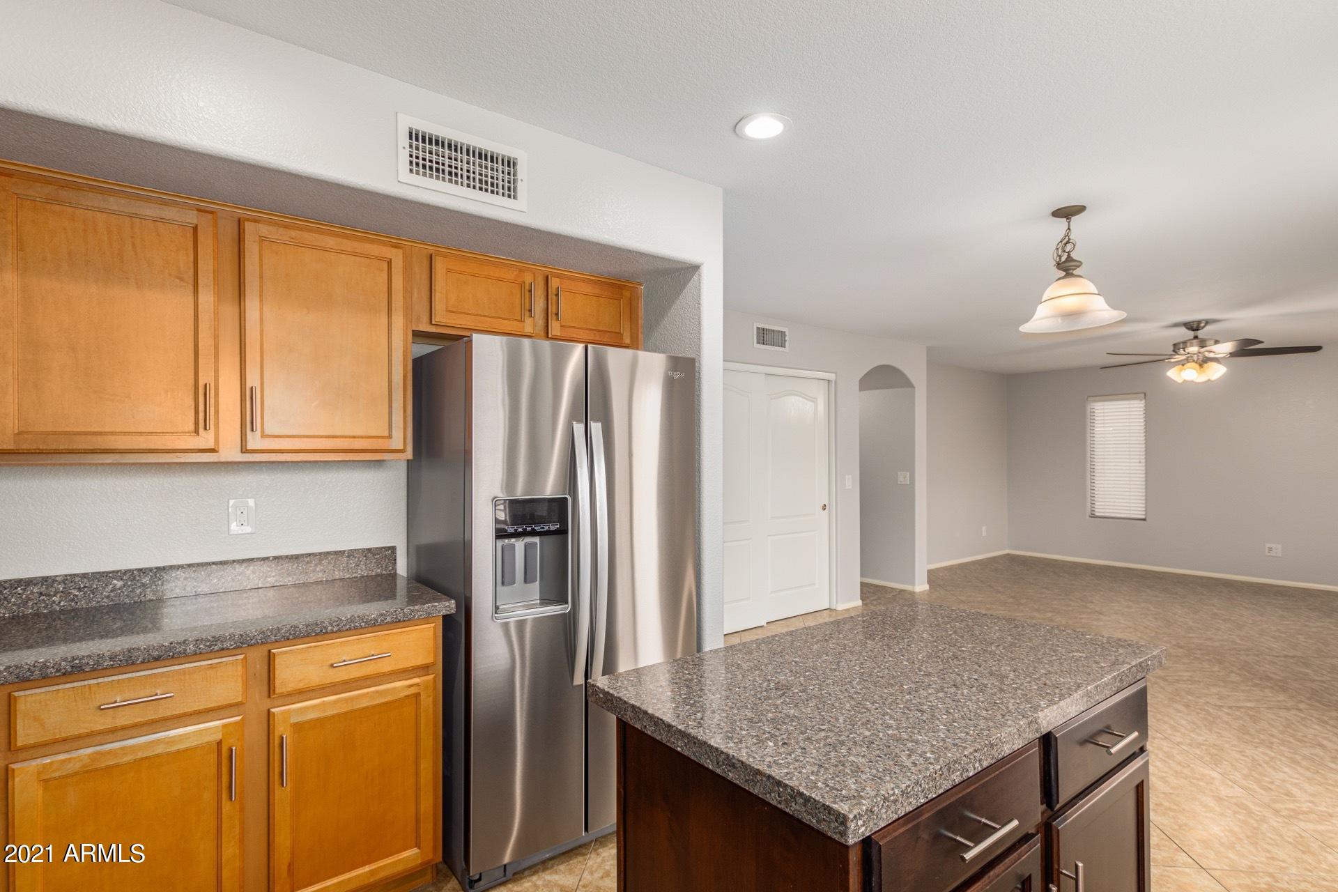 2438 West Running Deer Trail Phoenix, AZ 85085 - Photo 10 of 28 a kitchen with stainless steel appliances granite countertop a refrigerator and a sink