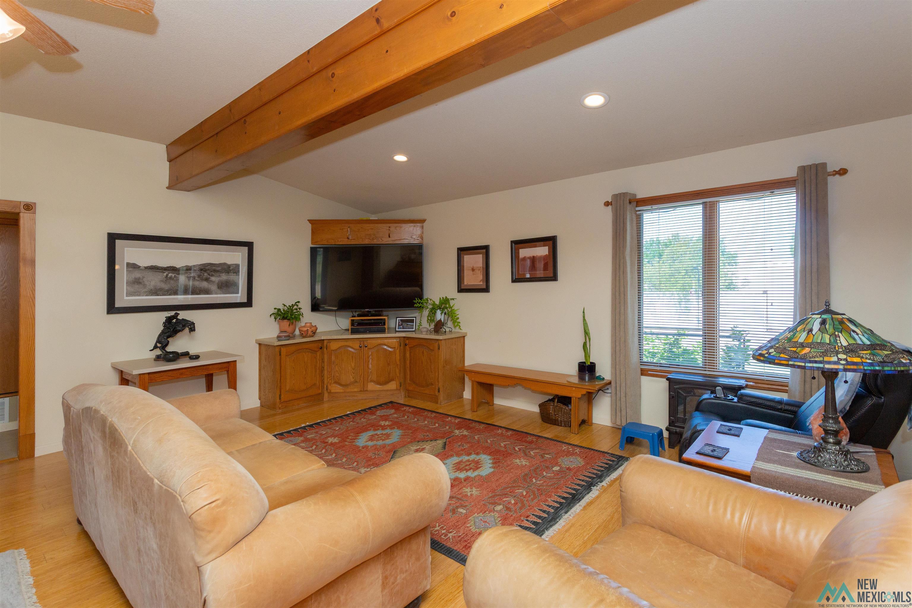 2012 South Haldeman Road Artesia, NM 88210 - Photo 11 of 96 Spacious living area featuring exposed wood beams, recessed lighting, and wood-finish flooring