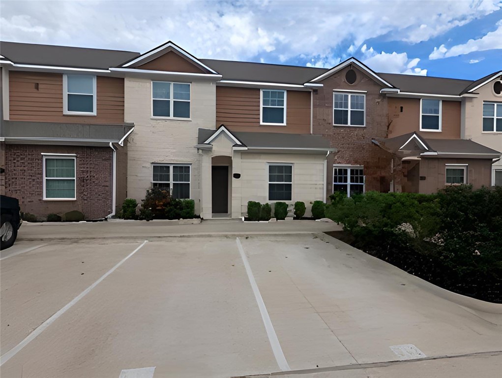 301 Southwest Parkway, Unit 351 College Station, TX 77840 - Photo 1 of 10 a front view of a house with a yard